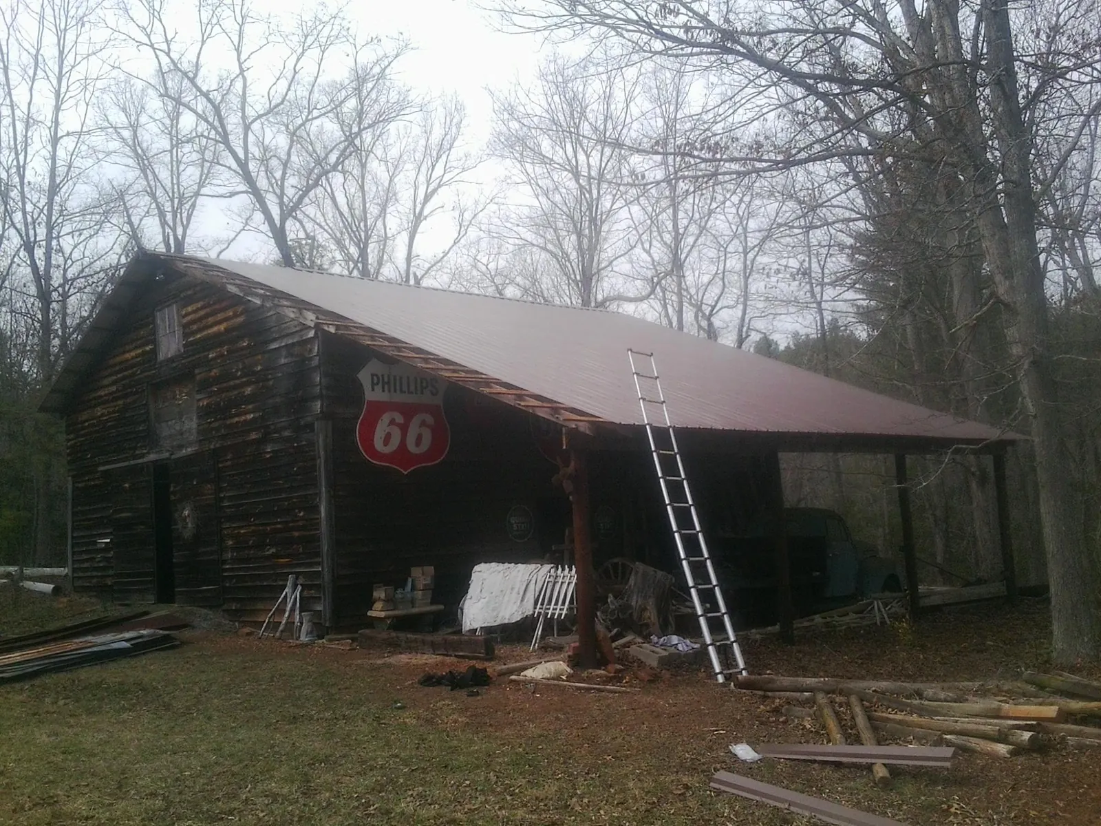 New metal roof on an open sided timber barn with a vintage sign in New Providence